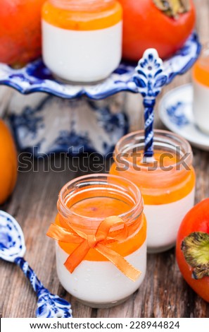 Italian dessert panna cotta in a jar with persimmon topping