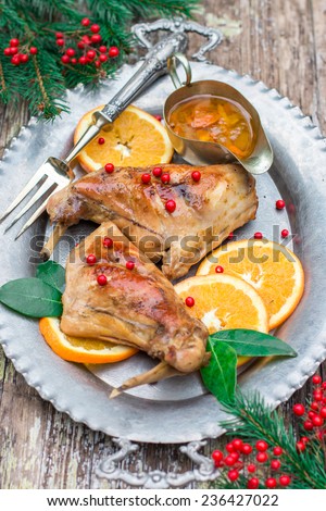 Christmas rabbit cooked with oranges on the silver plate