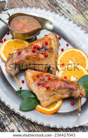 Christmas rabbit cooked with oranges on the silver plate