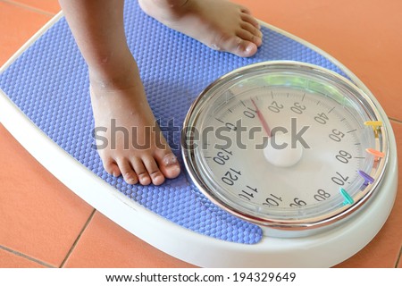view of scales on a floor and kids feet view of scales on a floor and kids feet