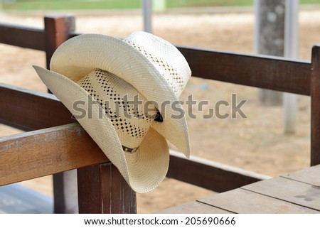 cowboy hat, light brown cowboy hat hanging on farm fence