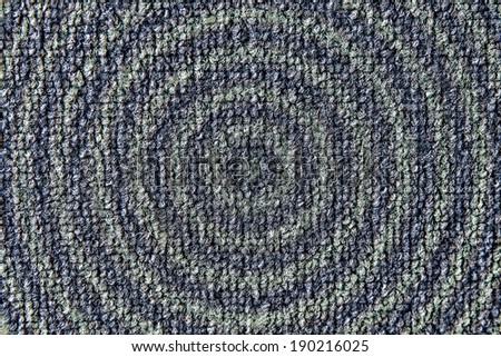 photograph shows a small shaggy rug in blue - green circles