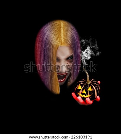 Female vampire holds in his hands the flaming pumpkins, hair rainbow