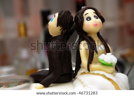 stock photo bride and groom funny and sugar figures on wedding cake