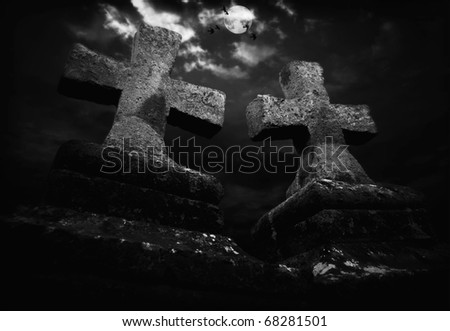 medieval Christ-stones against dramatically cloudy sky with crows and moon at night