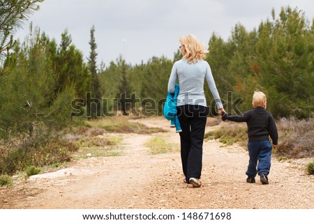 Happy Grandma  with her grandson walk on nature