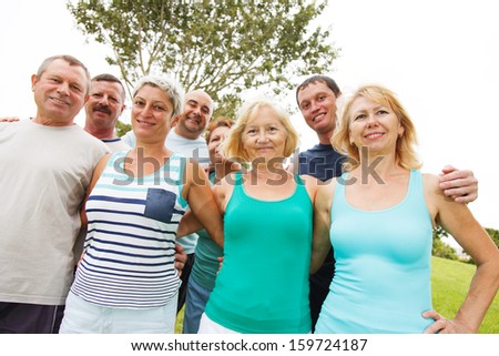 Group of happy men and women outside