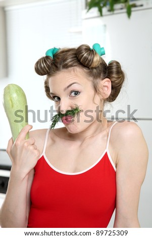 Funny housewife in the kitchen with vegetables.