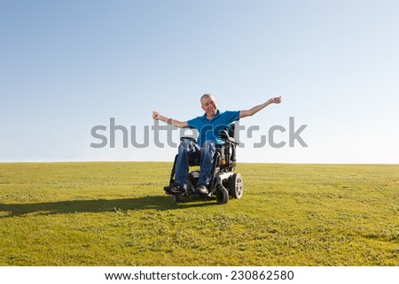 Disabled man in wheelchair shows freedom
