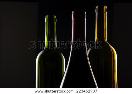 Three wine Bottle(green, yellow, red) Isolated on black Background.