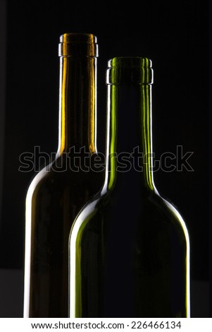 A wine(green, yellow) glass container with wine isolated black.