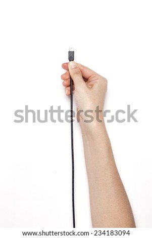 A female(woman) hand hold a black five pin cable(jack, plug, socket) isolated white, top view at the studio.