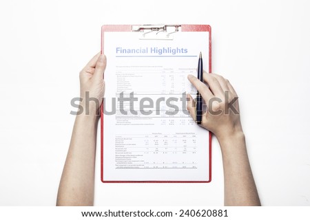A female(woman) hand hold a pen and red clipboard with graph paper(document, report) isolated white, top view at the studio.