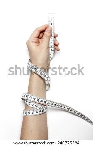 A female(woman) hand hold(reel, coil) a tape measure(tape line) isolated white at the studio.