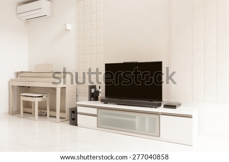LCD(internet) TV, storage, piano(an electronic organ), art wall at the white living room on the white marble.
