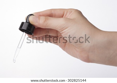 A woman(nurse, scientist) hands hold a spuit(dropping pipet, pipette, medicine dropper) dropping with liquid(fluid) for chemical at the laboratory isolated white.