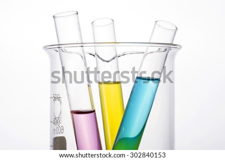 Test tube with blue(cyan), red(blood, pink, magenta), yellow liquid(fluid, water) in the beaker for chemical, health at the laboratory and white background.