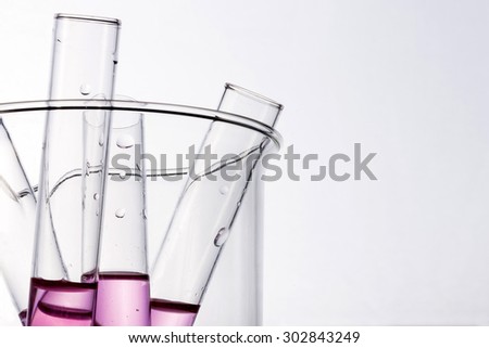 Test tube with red(blood, magenta, pink) liquid(fluid, water) in the beaker for chemical, health at the laboratory and white background.