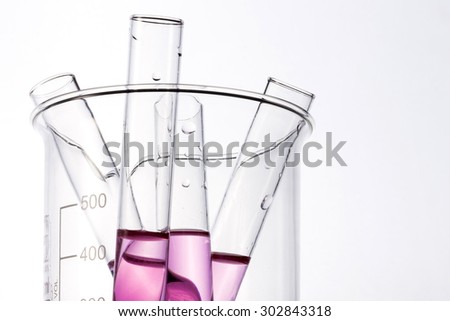 Test tube with red(blood, magenta, pink) liquid(fluid, water) in the beaker for chemical, health at the laboratory and white background.