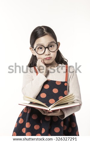 A asian(japan, chinese, korea) pretty girl hold a book and reading, thinking hard, have a questions with a worry isolated white at the studio.
