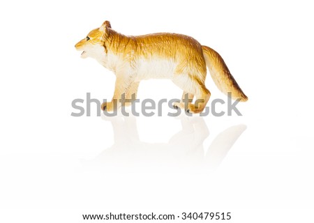 A rubber(plastic) toy of dog(fox) for kids, education side view isolated white.