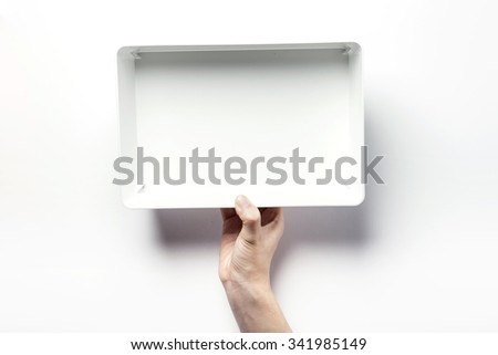A woman hands hold a empty(blank, vacant, hollow) white plastic box(container, case) for interior, living, top view isolated white at the studio.