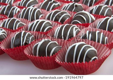 Chocolate Cake Balls with white candy melt accent stripping