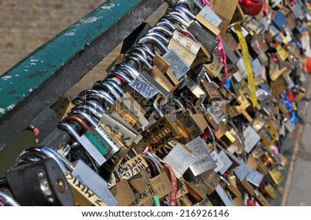 PARIS, FRANCE - August 1, 2011: The bridge at Pontiac de l\'Archeveche, hundreds of locks attached to the fence. People engrave locks, make a wish or confirm their love and toss the key into the Seine