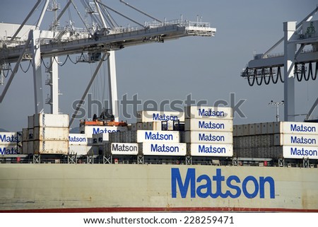 OAKLAND, CA - NOVEMBER 04, 2014: Port of Oakland, shipping containers being loaded on a Matson Cargo Ship. Matson provides shipping services Pacific wide, mainly to and from the Hawaiian Islands.