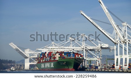 OAKLAND, CA - NOVEMBER 04, 2014: Port of Oakland, China Shipping Line Cargo Ship loading. China Shipping Line provides freight transport, storage, and electronic data interchange services worldwide.