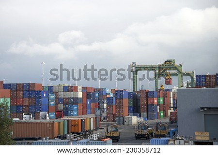 OAKLAND, CA - NOVEMBER 13, 2014: Port of Oakland, Constant activity is seen in and out of the terminal. as shipping containers unloaded from vessels in port are loaded on trains and trucks.