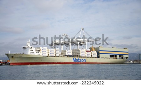 OAKLAND, CA - NOVEMBER 21, 2014: Port of Oakland, shipping containers being loaded on a Matson cargo ship. Matson provides shipping services Pacific wide, mainly to and from the Hawaiian Islands.
