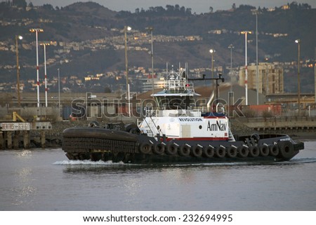 OAKLAND, CA - NOVEMBER 23, 2014: American Navigation (AmNav) Tugboat REVOLUTION. AMNAV Maritime Services has been the leading provider of marine and harbor services in the San Francisco Bay area.