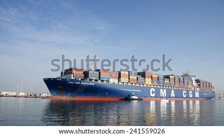 OAKLAND, CA - JANUARY 04, 2014: Tugboats move vessels that should not move themselves, such as ships in a crowded harbor. Multiple Tugboats escort CMA CGM Cargo Ship CENTAURUS from the Port of Oakland