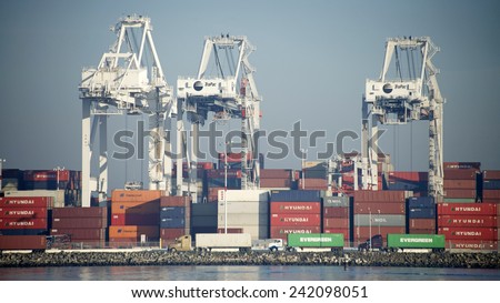 OAKLAND, CA - JANUARY 06, 2015: The Port of Oakland the fifth busiest container port in the United States. Hundreds of containers enter and leave each day via truck, rail and ships.