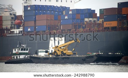 OAKLAND, CA - JANUARY 08, 2015: GWENDOLYN GRACE pushing a barge with a tractor to it\'s destination. Marine Express, Inc. provides complete marine service in the San Francisco Bay and its tributaries.