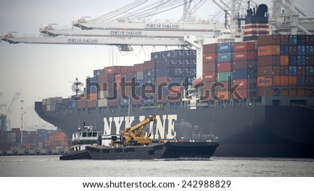OAKLAND, CA - JANUARY 08, 2015:  GWENDOLYN GRACE pushing a barge with a tractor to it\'s destination. Marine Express, Inc. provides complete marine service in the San Francisco Bay and its tributaries.