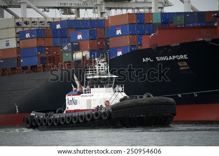 OAKLAND, CA - FEBRUARY 07, 2015: AmNav Tugboat REVOLUTION at the Port of Oakland. American Navigation is committed to providing the Best Value with the highest standards in reliability and safety.