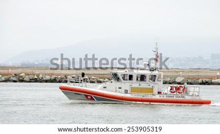 OAKLAND, CA - FEBRUARY 17, 2015: U.S. Coast Guard vessel passing the Port of Oakland. The Coast Guard Base is located on an artificial island in the Oakland Estuary between Oakland and Alameda.
