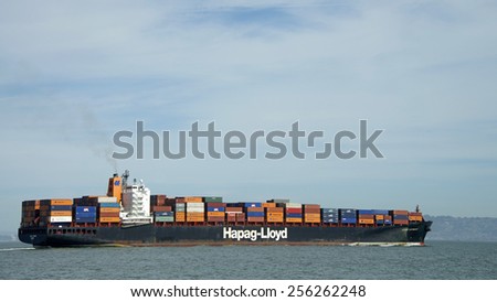 SAN FRANCISCO, CA - FEBRUARY 26, 2015: Hapag-Lloyd Cargo Ship KOBE EXPRESS in the San Francisco Bay en route to the Port of Oakland, the fifth busiest container port in the United States.