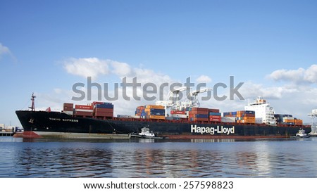 OAKLAND, CA - MARCH 02, 2015: Tugs move vessels that should not move themselves, such as ships in a crowded harbor. Z-THREE and Z-FOUR assist Hapag-Lloyd TOKYO EXPRESS into the Port of Oakland.