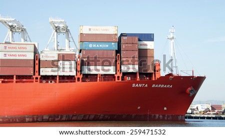 OAKLAND, CA - MARCH 09, 2015: Close up on the Bow of  Hamburg SUD Cargo Ship SANTA BARBARA, loaded with shipping containers, entering the Port of Oakland.