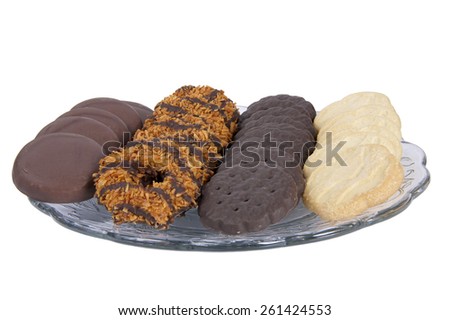 ALAMEDA, CA - MARCH 07, 2015: Illustrative Editorial of a plate with four of the most popular original Girl Scout Cookies. Original trefoil, Thin Mints, Samoas and Tag-a-longs. Isolated on White.