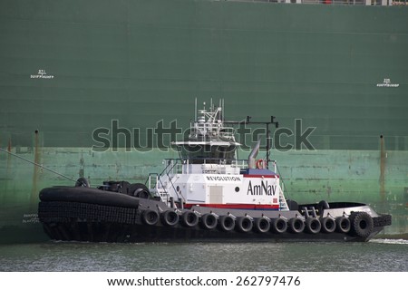 OAKLAND, CA - MARCH 22, 2015: AmNav tugboat REVOLUTION performing tugboat assistance. American Navigation was a pioneer in developing tugboats with high horsepower engines in relatively small hulls.
