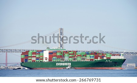 OAKLAND, CA - APRIL 04, 2015: Evergreen Cargo Ship EVER LOGIC entering the Port of Oakland Outer Harbor. EVERGREEN MARINE is the fourth largest company of itÃ¢Â?Â?s type.