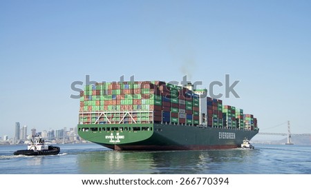 OAKLAND, CA - APRIL 04, 2015:  Evergreen Cargo Ship EVER LOGIC departing the Inner Harbor heading towards the Outer Harbor at the Port of Oakland.