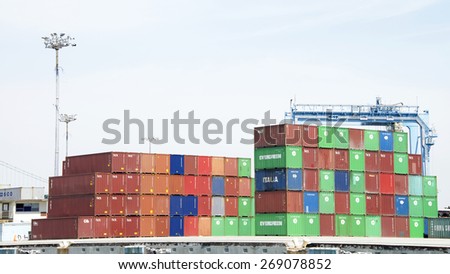 SAN PEDRO, CA - APRIL 10, 2015: Brightly colored shipping containers stacked on the docks at the Port of Los Angeles. Containers are organized and placed algorithmically for efficient transport.
