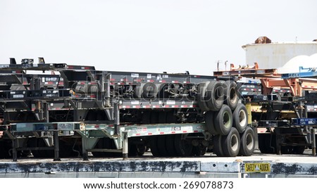 SAN PEDRO, CA - APRIL 10, 2015: Stacks of chassis  await containers and trucks in the Port of Los Angeles. The truck chassis are stacked when not in use to maximize the use of storage space.