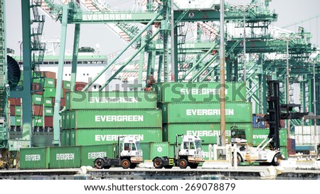 SAN PEDRO, CA - APRIL 10, 2015: Evergreen terminal at the Port of Los Angeles. trucks drop off shipping containers then drive down the dock to pick up the next load.