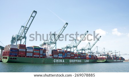 SAN PEDRO, CA - APRIL 10, 2015:  China Shipping Cargo Ships XIN YA ZHOU and XIN FEI ZHOU loading at the Port of Los Angeles. The Port of LA is the busiest container port in the United States.